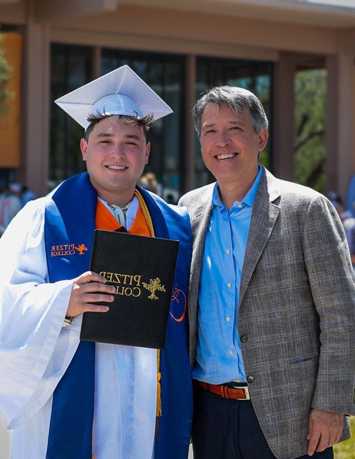 Alex Wise stands with his father at commencement